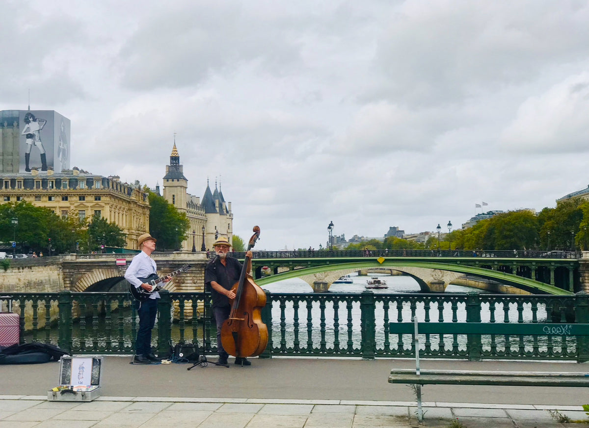 live musicians on the bridge over seine paris france